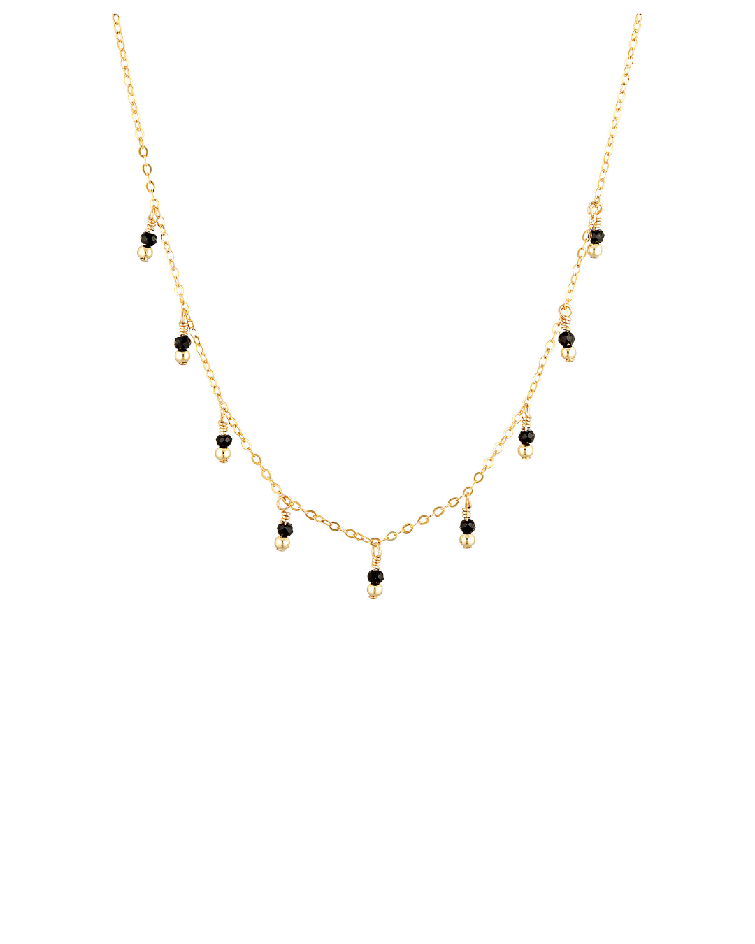 Gold necklace with black spinel gemstones on a white background