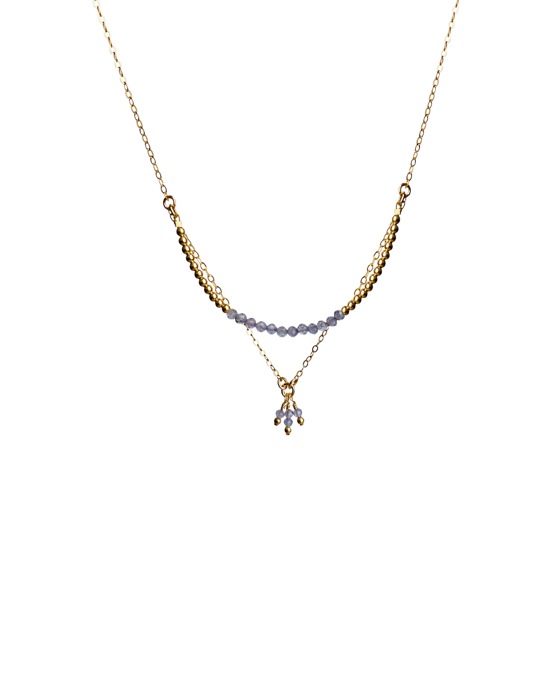 Delicate gold necklace with tanzanite gemstones on a white background