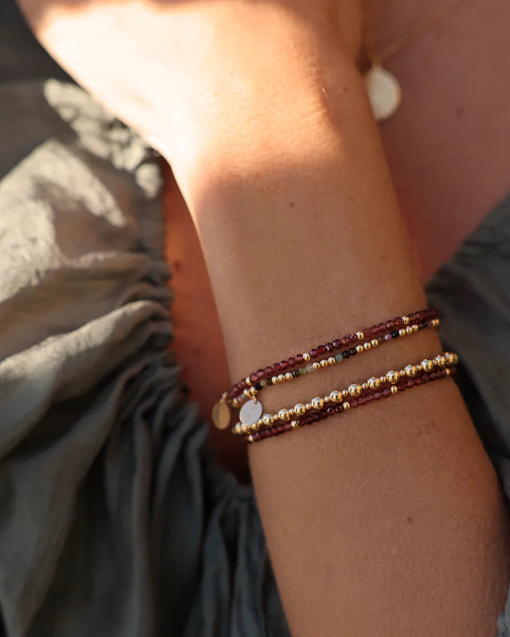 Model wearing bracelet with two bead sizes hand-strung onto durable stretch cord