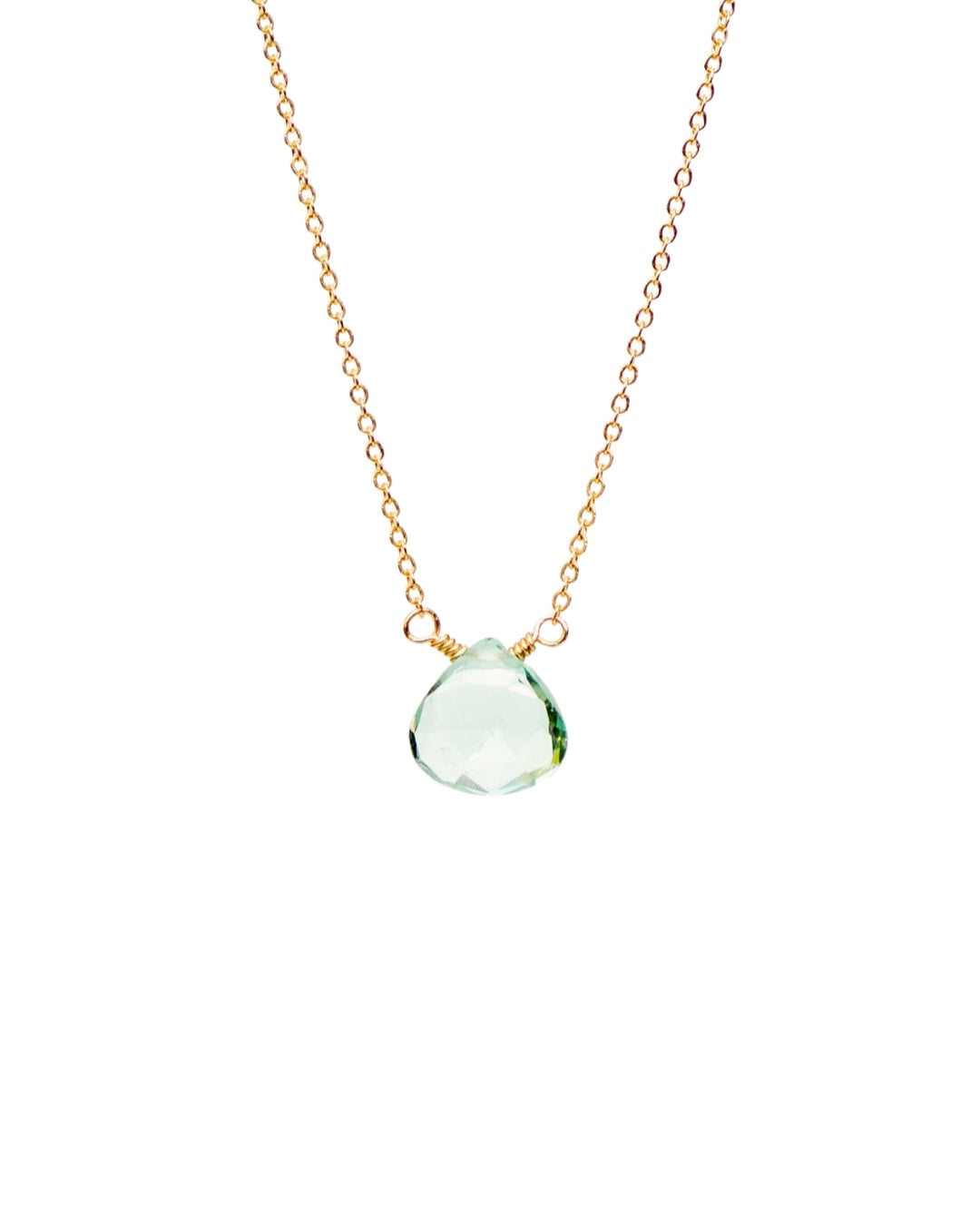 Gold necklace with a blue topaz teardrop pendant on a white background