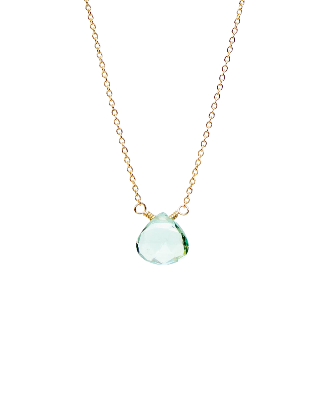 Gold necklace with a blue topaz teardrop pendant on a white background
