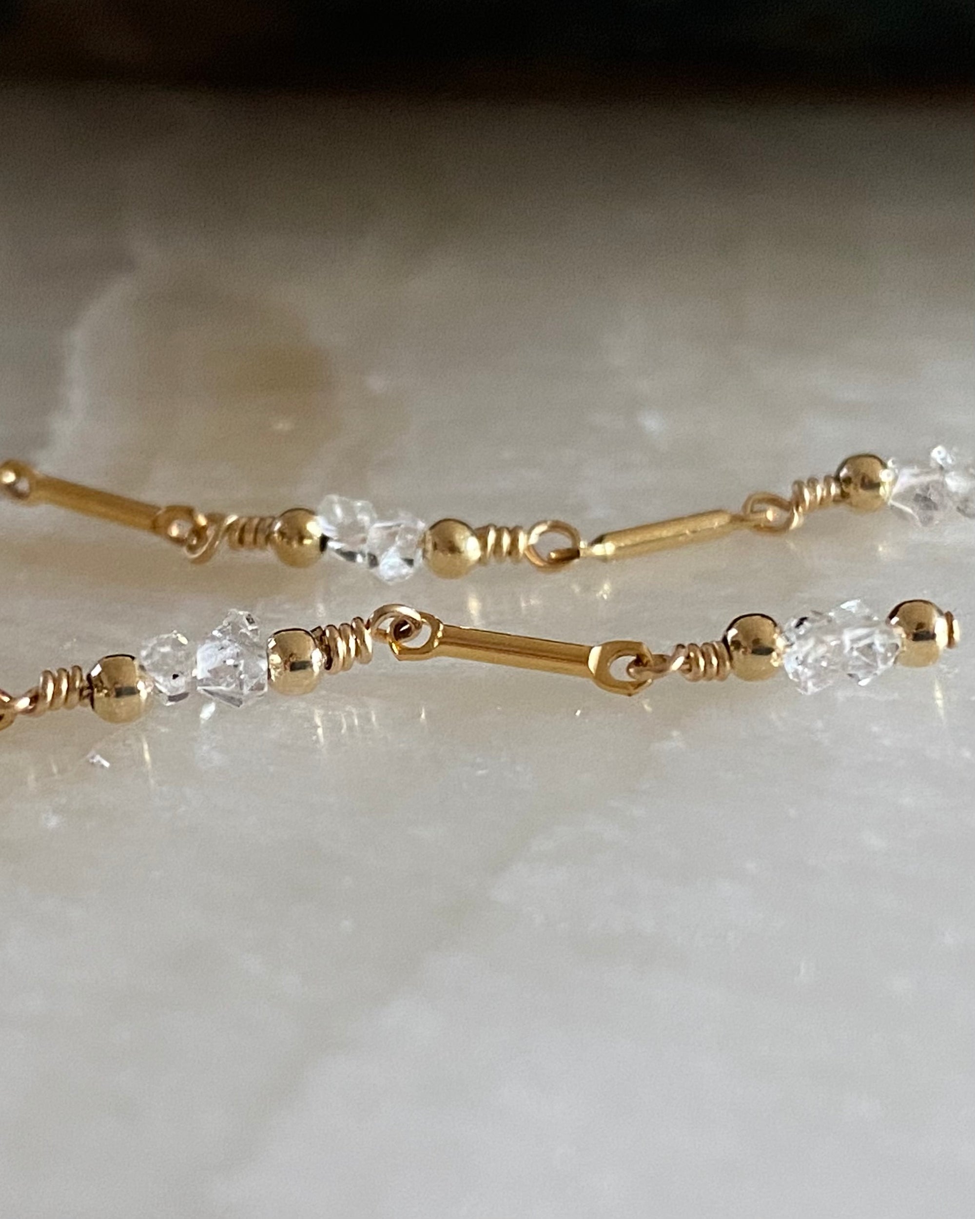 Close up of Gold and herkimer diamond beaded earrings