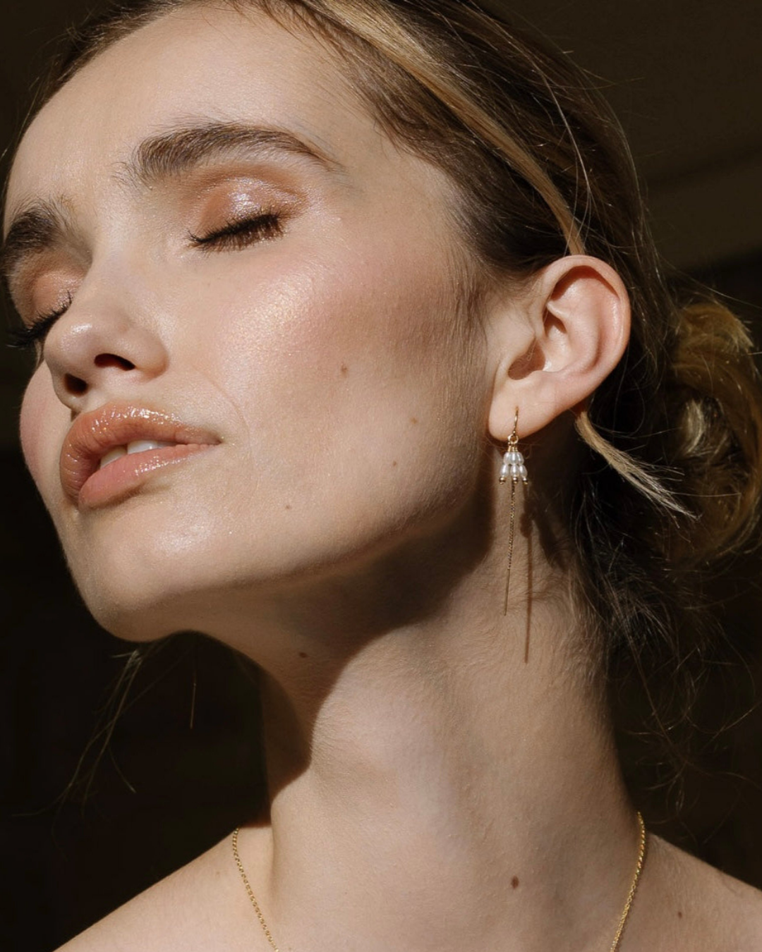 Close-up of a woman wearing elegant earrings with a blurred background