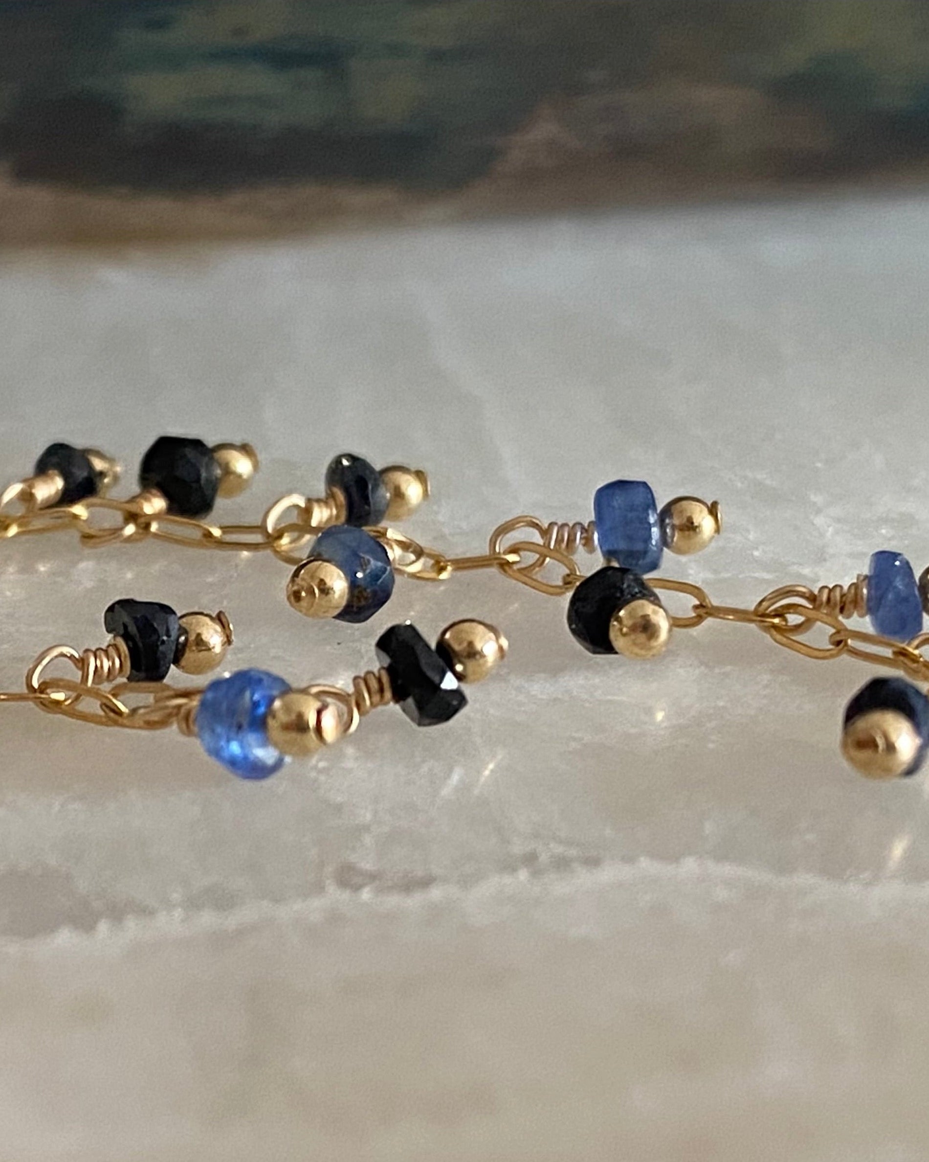 Sapphire beaded earrings on a marble background