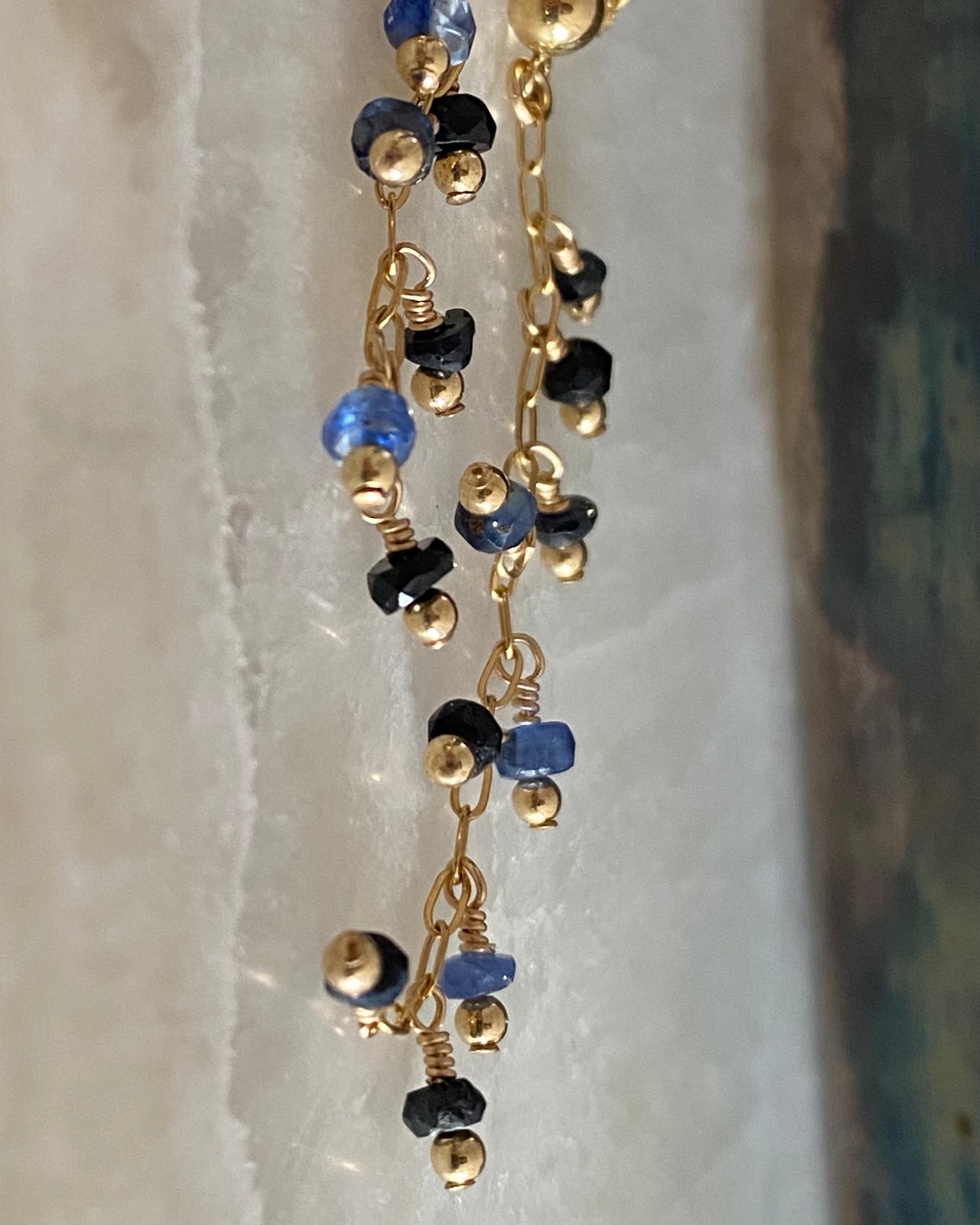 Sapphire beaded earrings on a marble background