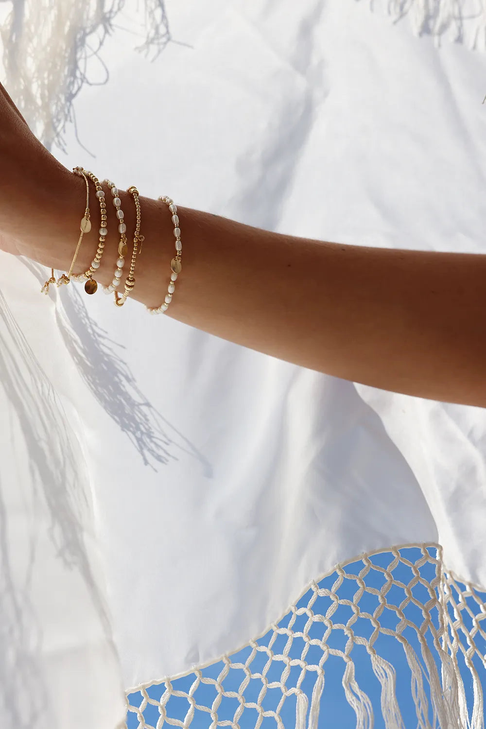 Pear bracelet hand-threaded onto durable stretch cord and designed with radiant gold beads and lustrous pearls