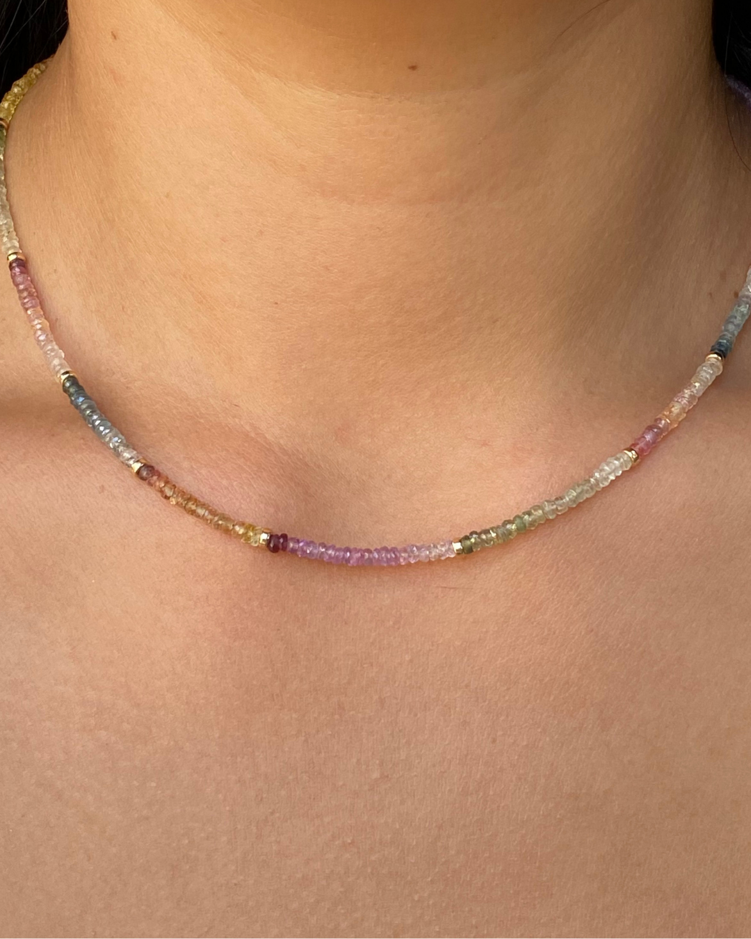 Multicolored beaded necklace on a person's neck