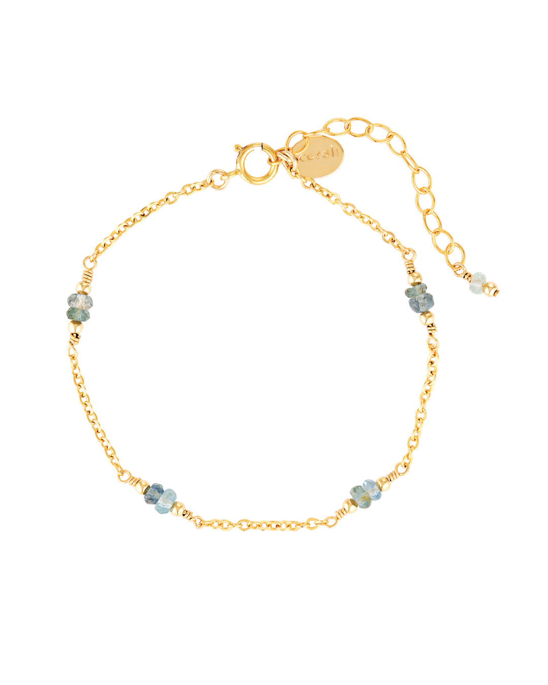 Gold chain bracelet with aquamarine gemstones on white background.