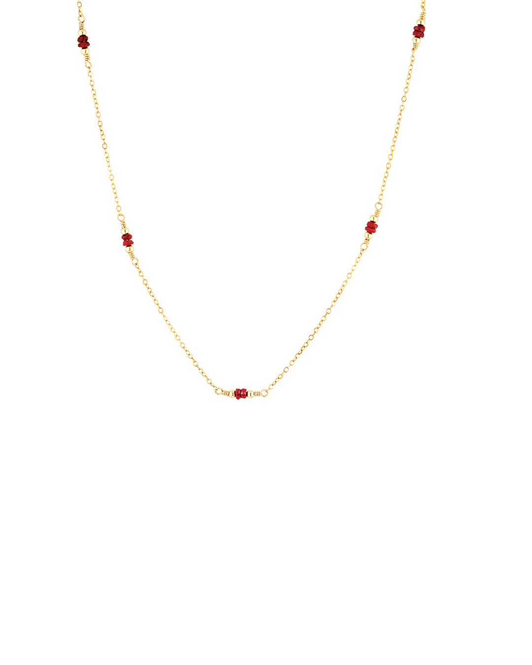 Gold necklace with red ruby beads on a white background