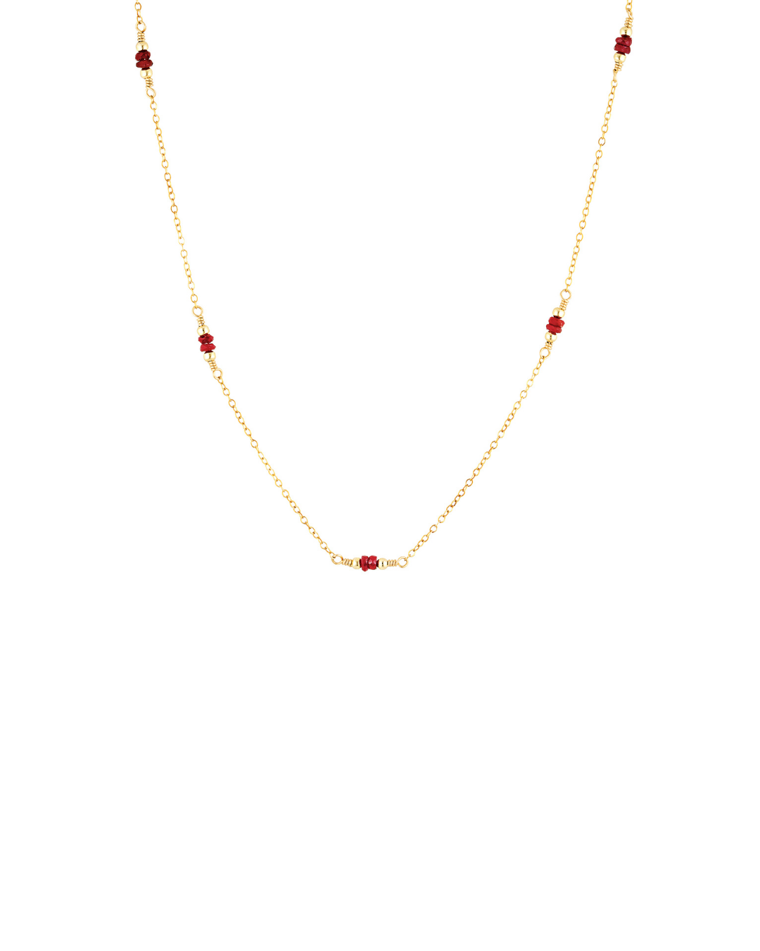 Gold necklace with red ruby beads on a white background