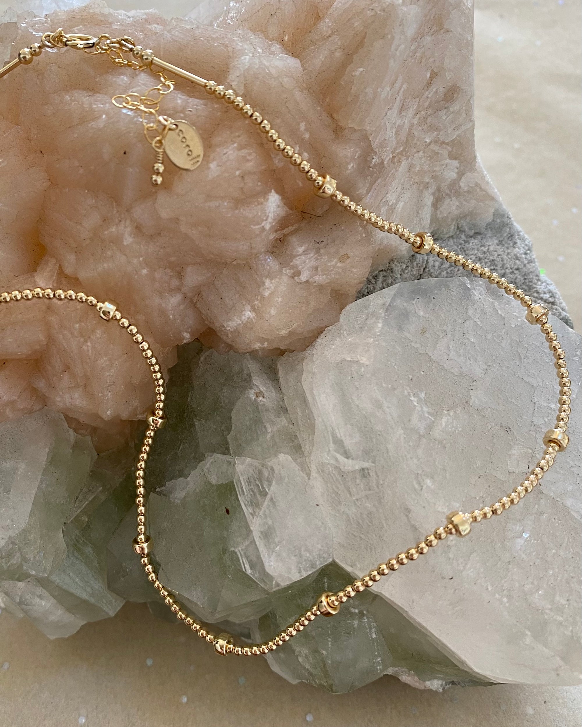 Gold beaded necklace on a crystal 