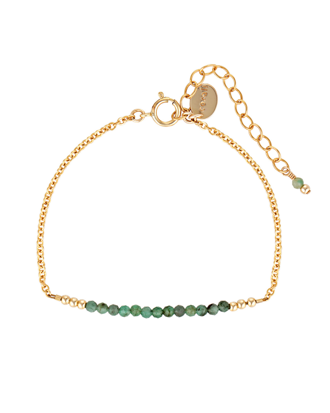 Gold bracelet with green emerald gemstones on a white background