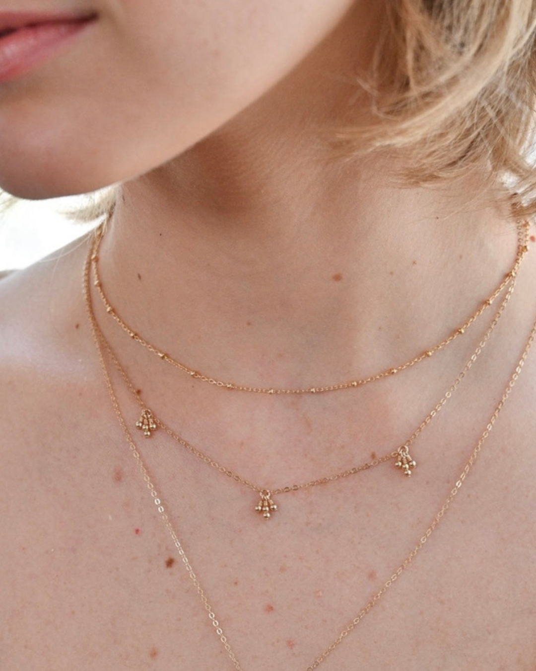 Layered gold necklaces