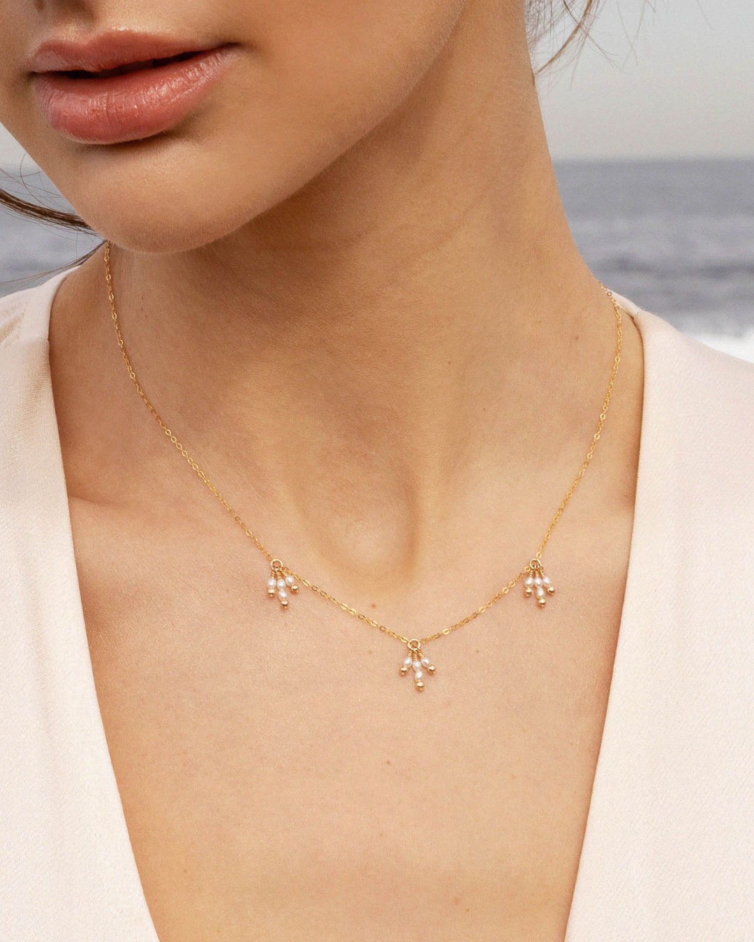 Gold and pearl necklace on woman's neck