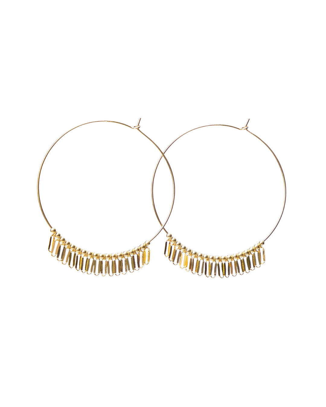 Gold hoop earrings with dangling beads on a white background