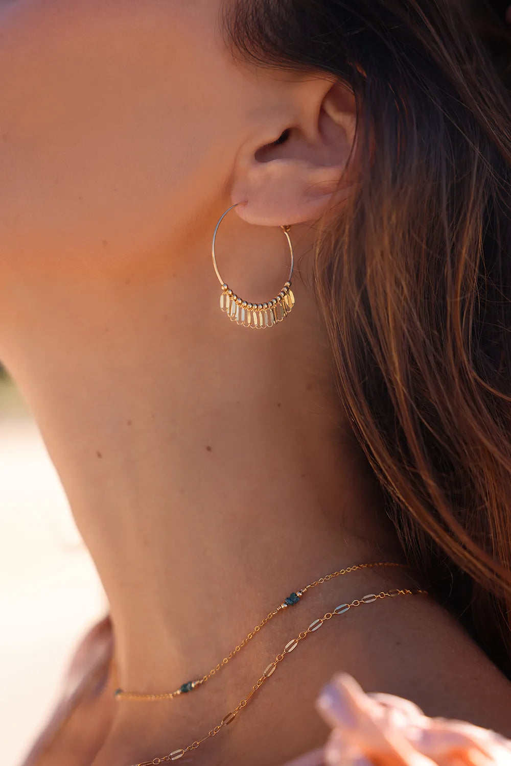 Model wearing gold necklace with fine links