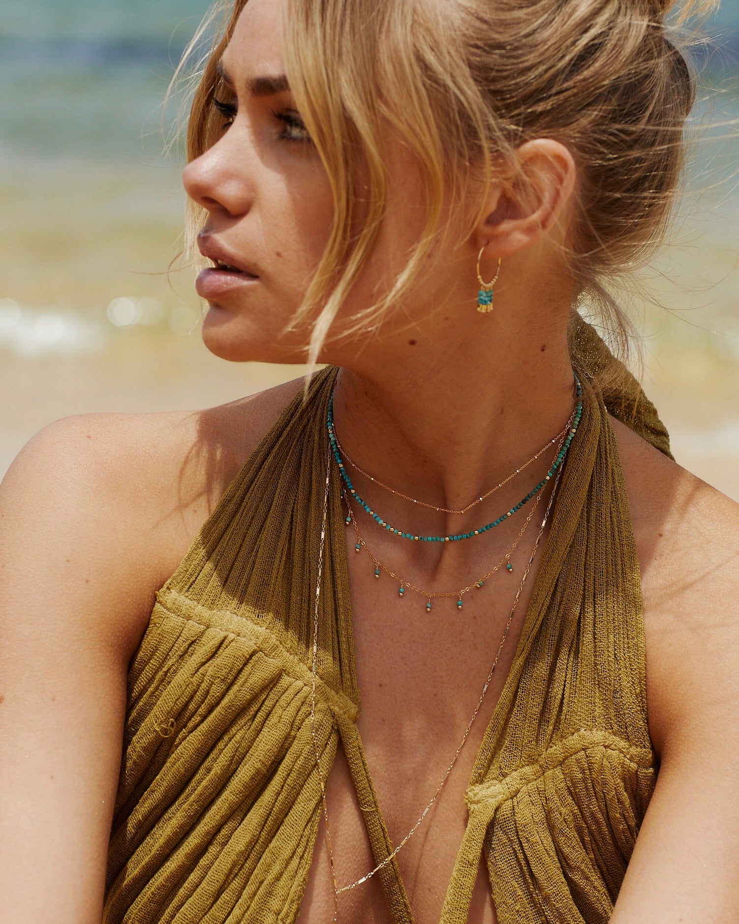 delicate gold necklace with turquoise gemstones