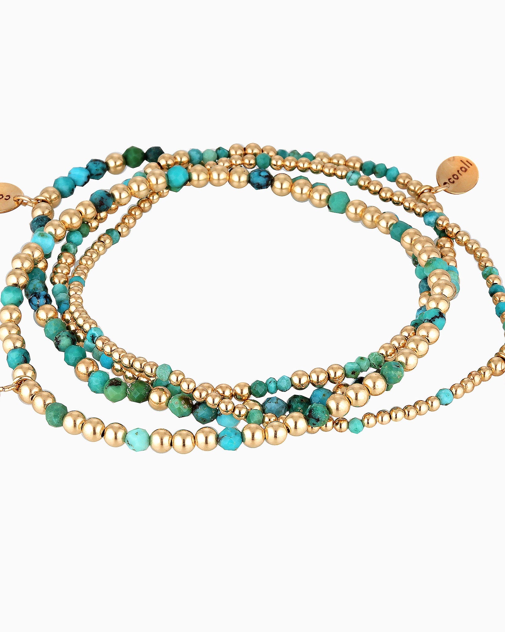 A set of turquoise and gold-colored bead bracelets hand threaded on stretch cord.